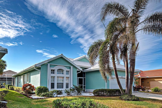 view of front of house with a garage and a front yard