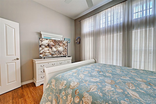 bedroom with wood-type flooring and ceiling fan