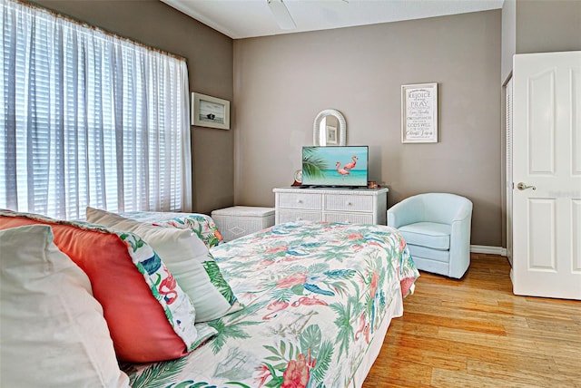 bedroom featuring multiple windows and light wood-type flooring