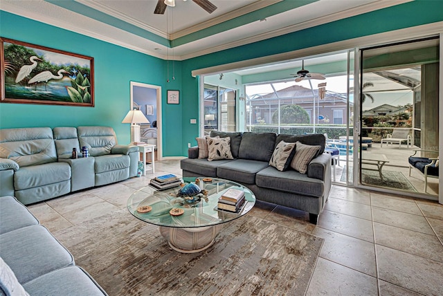 tiled living room with ornamental molding and ceiling fan