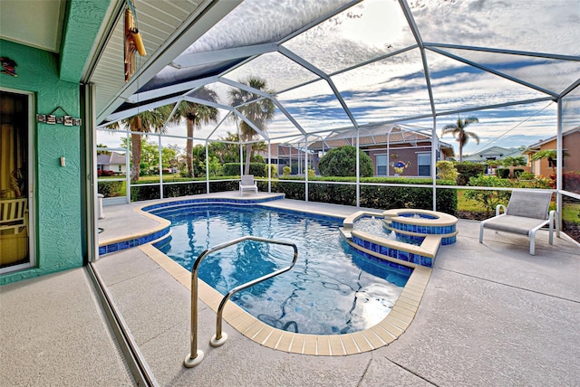 view of pool with a lanai, a patio, and an in ground hot tub