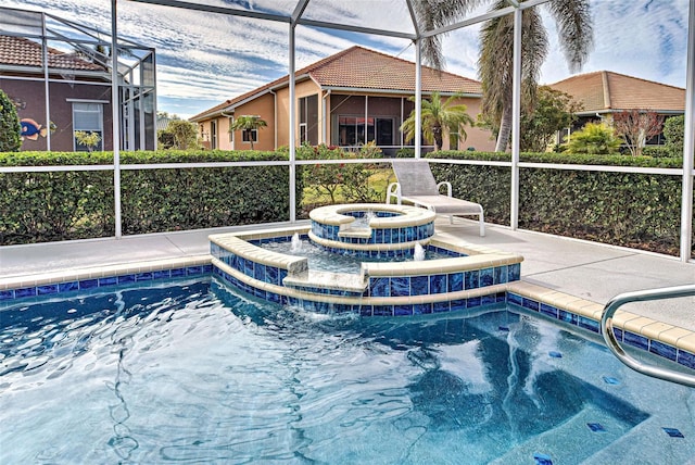 view of swimming pool with an in ground hot tub and a lanai