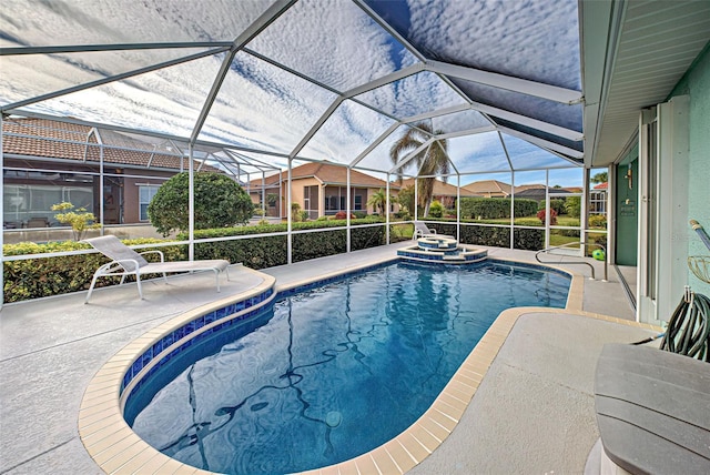 view of pool with an in ground hot tub, a lanai, and a patio area