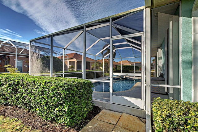 view of pool featuring a patio area and glass enclosure