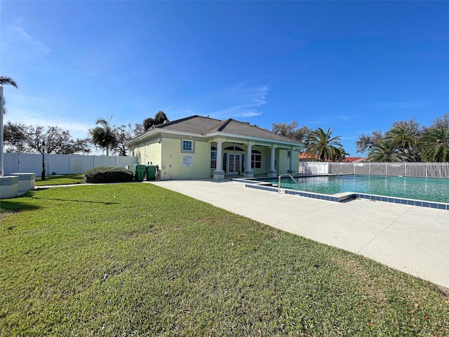 view of swimming pool with a yard and a patio area