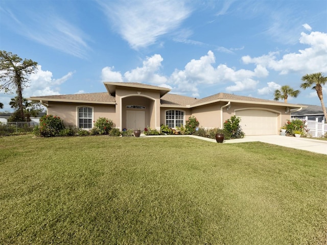 view of front of home with a front yard and a garage