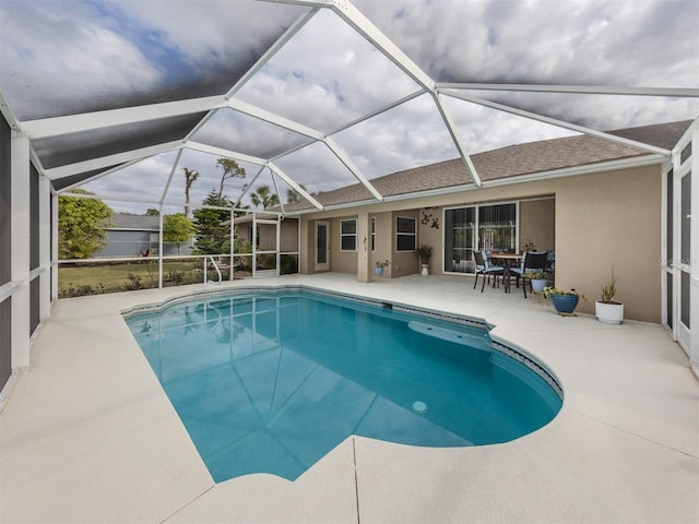 view of swimming pool with a patio area and a lanai