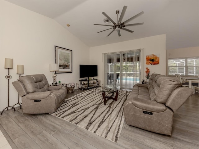 living room featuring ceiling fan, a wealth of natural light, light hardwood / wood-style floors, and lofted ceiling