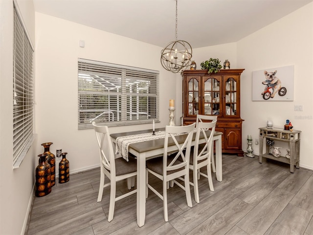 dining room featuring hardwood / wood-style flooring and a chandelier