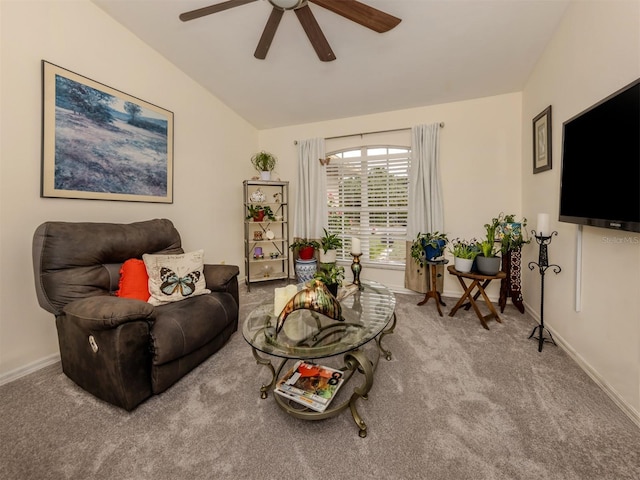 living room with ceiling fan, carpet flooring, and vaulted ceiling