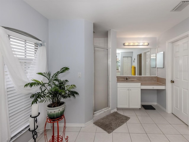 bathroom with walk in shower, tile patterned floors, and vanity