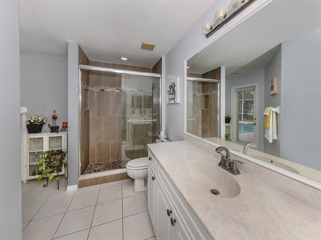 bathroom featuring toilet, vanity, an enclosed shower, and tile patterned flooring