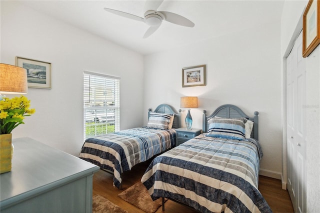 bedroom featuring dark wood-type flooring, ceiling fan, and a closet