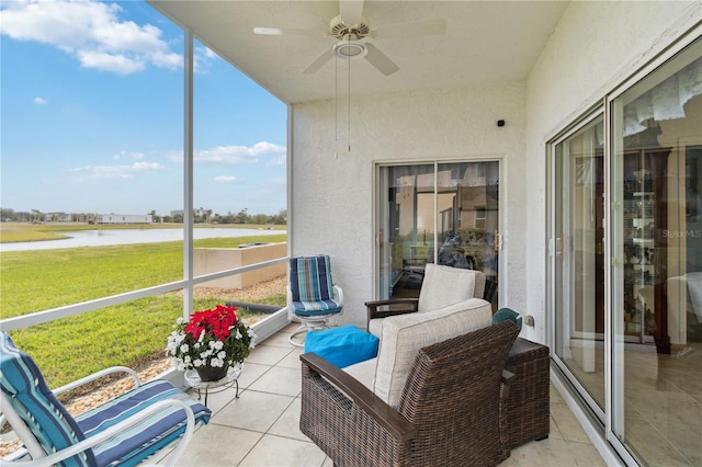 sunroom with a water view and ceiling fan