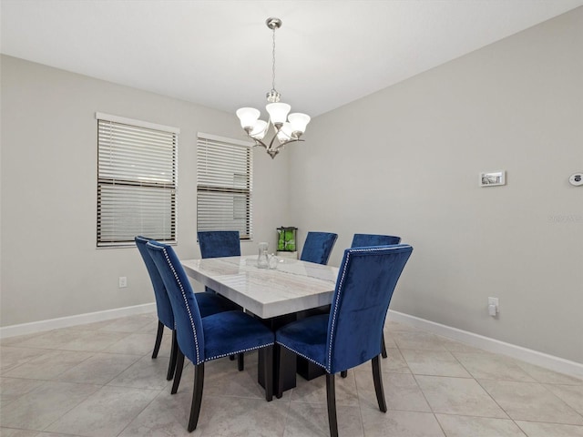 tiled dining area with a notable chandelier