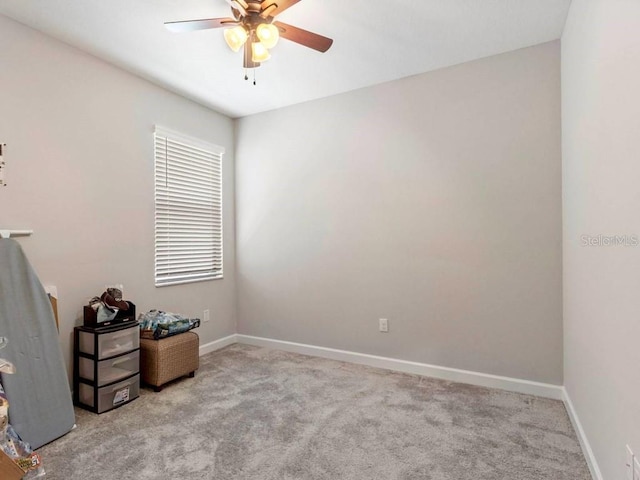 carpeted empty room featuring ceiling fan