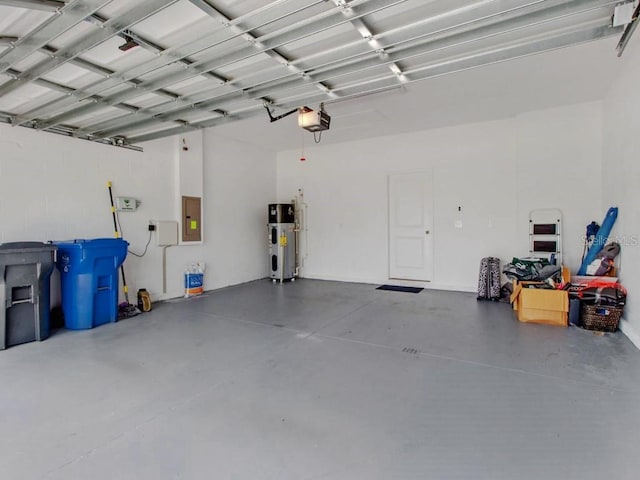 garage with electric panel, hybrid water heater, and a garage door opener