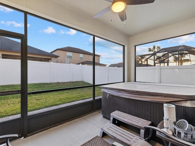 sunroom / solarium with ceiling fan and a jacuzzi