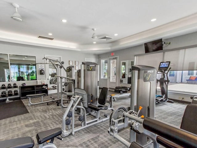 gym featuring ceiling fan, carpet flooring, french doors, and a tray ceiling