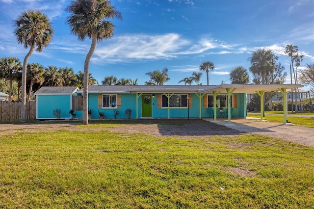 single story home featuring a front yard and a carport