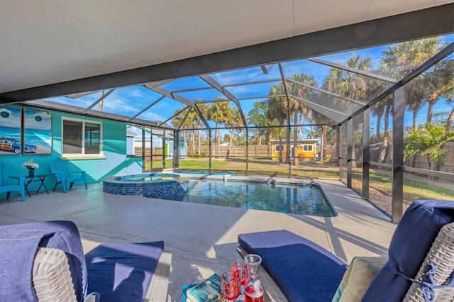 view of swimming pool with a patio area, glass enclosure, and an in ground hot tub