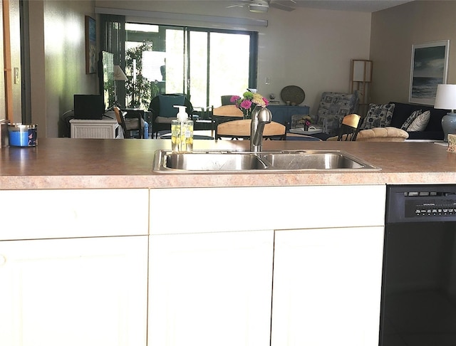 kitchen with sink, white cabinets, black dishwasher, and ceiling fan