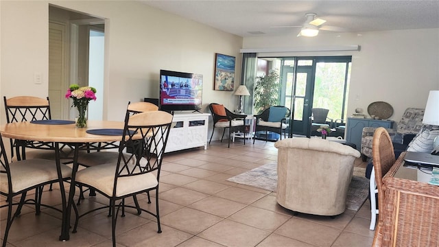 tiled dining area featuring ceiling fan