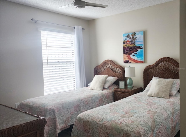 bedroom with ceiling fan and a textured ceiling