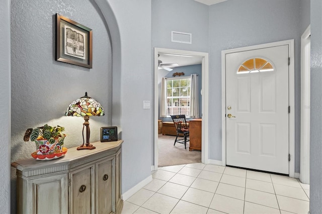 entryway with light tile patterned flooring and ceiling fan