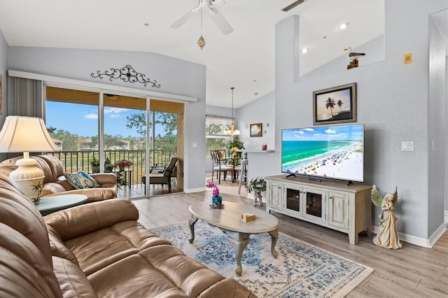 living room featuring lofted ceiling, light hardwood / wood-style flooring, and ceiling fan