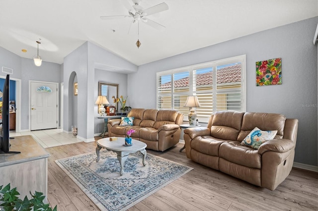 living room featuring ceiling fan, lofted ceiling, and light hardwood / wood-style floors