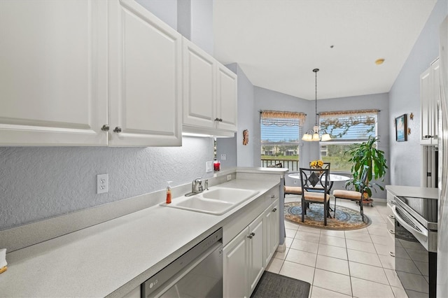 kitchen featuring white cabinetry, appliances with stainless steel finishes, sink, and decorative light fixtures