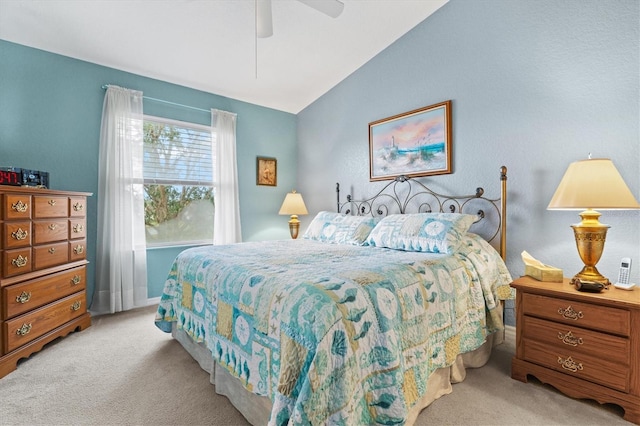 carpeted bedroom featuring ceiling fan and vaulted ceiling