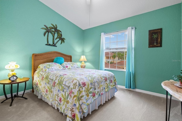 carpeted bedroom with vaulted ceiling and ceiling fan