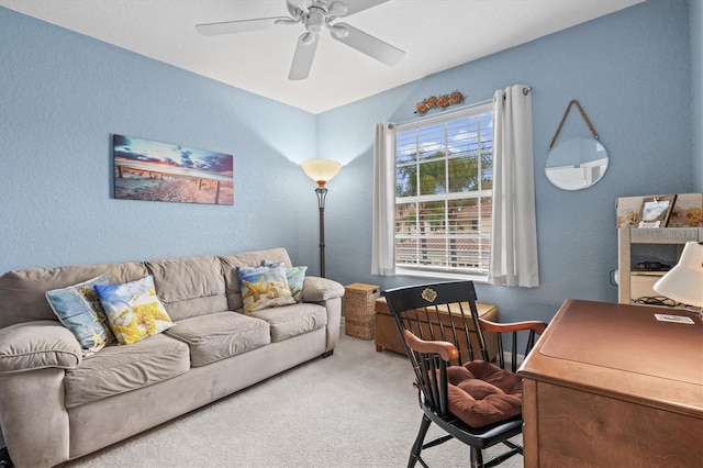 carpeted office space with ceiling fan