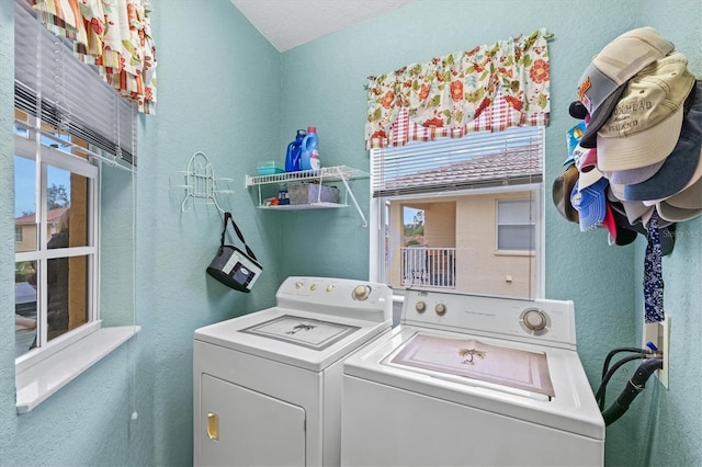 clothes washing area featuring independent washer and dryer and a healthy amount of sunlight