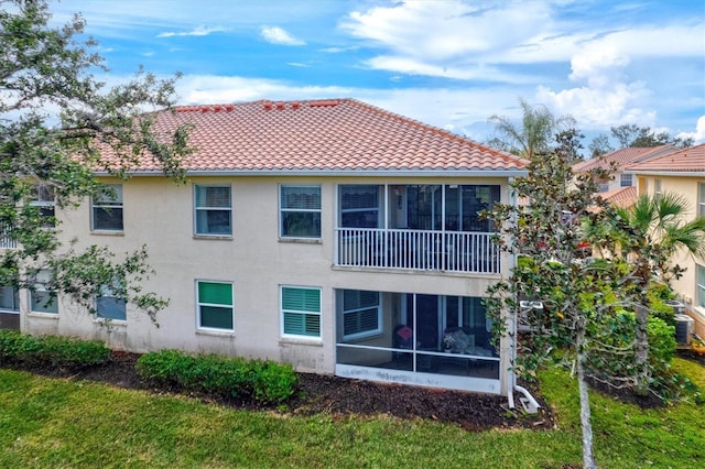 back of house featuring a sunroom