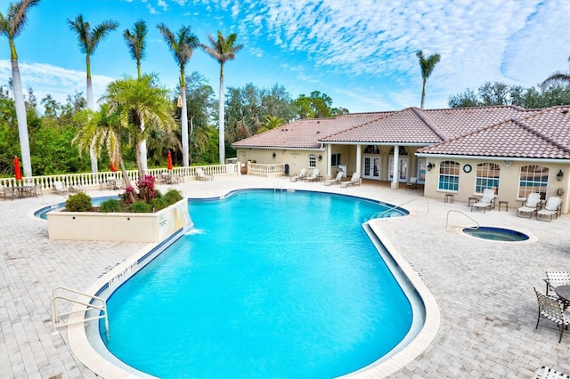 view of swimming pool with a patio and a community hot tub