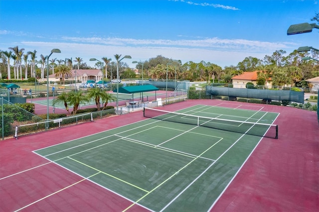 view of tennis court with basketball hoop