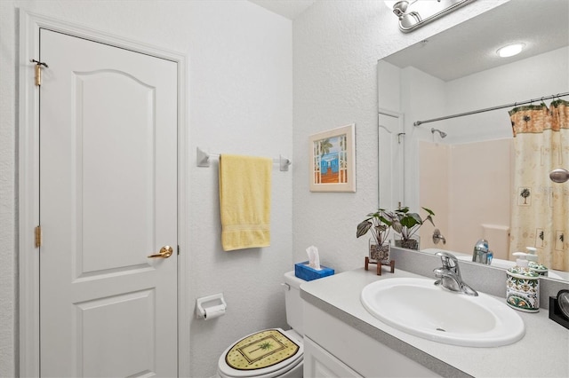 bathroom with vanity, toilet, and a shower with shower curtain