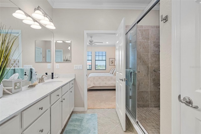 bathroom featuring tile patterned floors, ornamental molding, a shower with door, and vanity