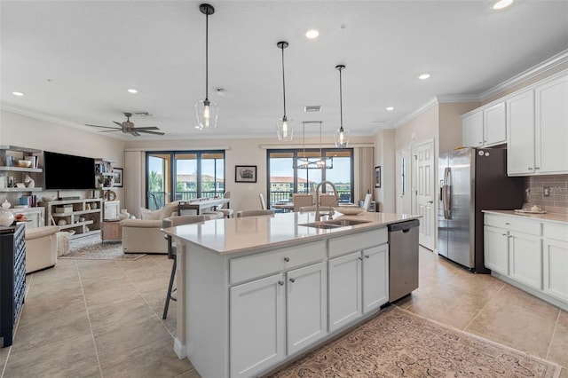 kitchen featuring white cabinetry, appliances with stainless steel finishes, sink, and a center island with sink