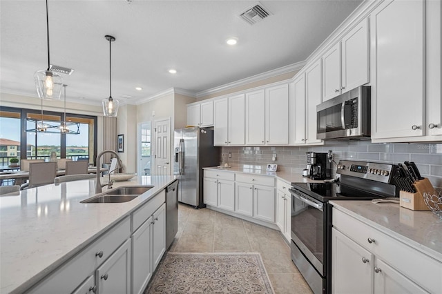 kitchen with pendant lighting, stainless steel appliances, and white cabinets