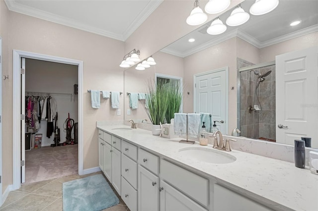 bathroom featuring vanity, crown molding, a shower with shower door, and tile patterned floors