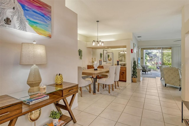 dining room with an inviting chandelier and light tile patterned floors