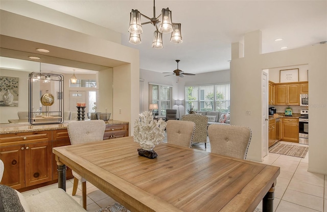 dining room with light tile patterned floors and ceiling fan