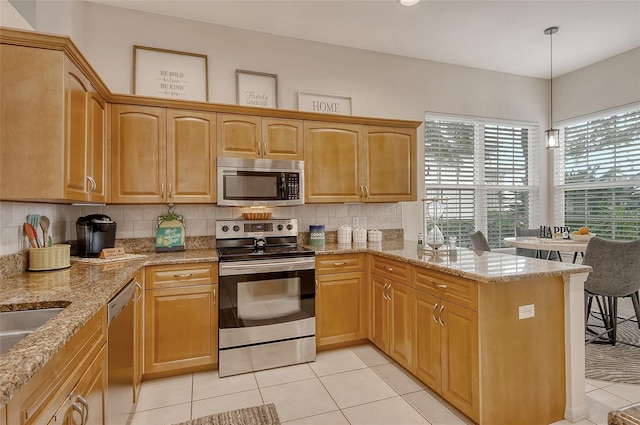 kitchen featuring pendant lighting, light tile patterned floors, appliances with stainless steel finishes, backsplash, and light stone counters