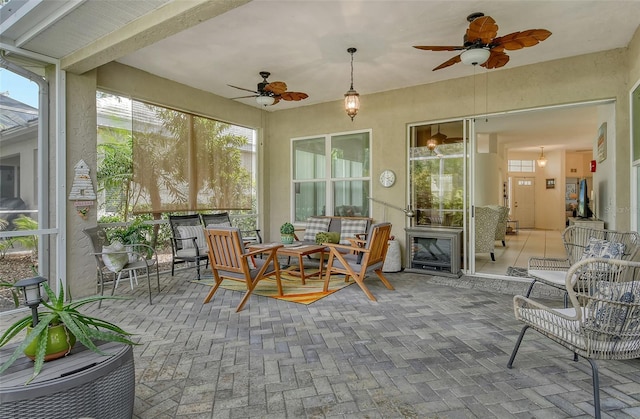 sunroom with ceiling fan