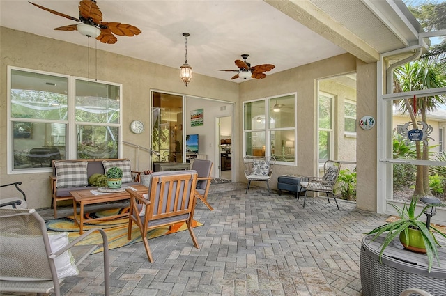 sunroom / solarium with ceiling fan