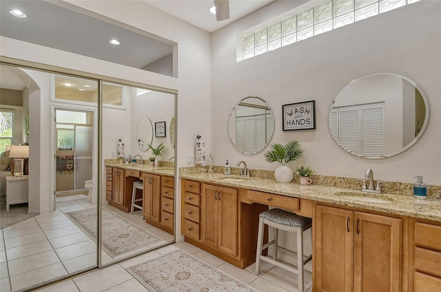 bathroom featuring plenty of natural light, tile patterned floors, and toilet